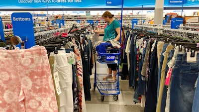 In this July 21, 2021 photo, a consumer shops at a retail store in Morton Grove, Ill. The fastest inflation in 40 years squeezed retailers during the first quarter, alarming investors worried about the broader economy's outlook. Earnings reports from Walmart, Target and Amazon this month showed higher costs are hurting retailers' operations.