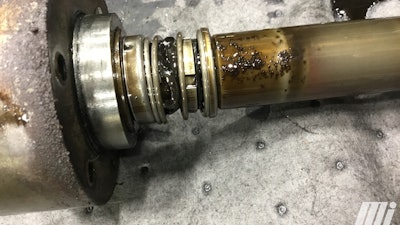 Leak from a gear pump that was pumping petroleum-based oil. The seal has Buna-N elastomers on it, which are swollen and wrinkled, and had pulled away from the rotary part of the seal—thus causing the leak.