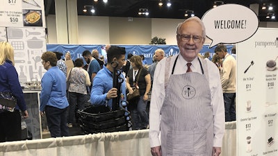 A cutout of Berkshire Hathaway CEO Warren Buffett greets shareholders at the Pampered Chef booth at the company's annual meeting, Friday, APril 29, 2022, in Omaha, Neb.. Tens of thousands of shareholders are expected Saturday to attend the company's first in-person meeting since the pandemic began.