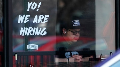 A hiring sign is displayed at a restaurant in Schaumburg, Ill., April 1, 2022.