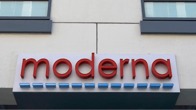 In this Dec. 15, 2020, file photo, a sign for Moderna, Inc. hangs on its headquarters in Cambridge, Mass.