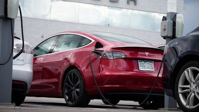 A 2021 Model 3 sedan is connected to a charger at a Tesla dealership on June 27, 2021, in Littleton, Colo. The National Highway Traffic Safety Administration said Thursday, June 9, 2022, that it's upgrading the probe into an engineering analysis, another sign of increased scrutiny of the electric vehicle maker and automated systems that perform at least some driving tasks.