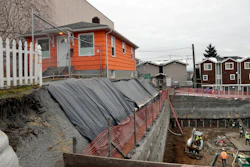 A single-family home on the edge of a multi-story, mixed-use construction site, Seattle, Dec. 27, 2017.