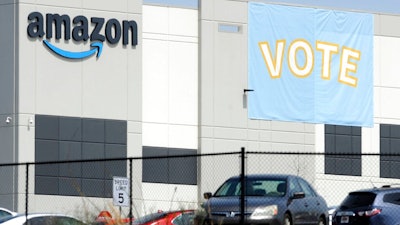 In this March 30, 2021 file photo, a banner encouraging workers to vote in labor balloting is shown at an Amazon warehouse in Bessemer, Ala. Following a string of union victories at Amazon and Starbucks, a group of prominent progressive grantmakers is seeking to put a total of $20 million into a coalition with organized labor that will steer funds to organizing and advocacy campaigns in the South.