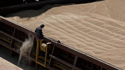 An employee of grain handler Comvex oversees the unloading of Ukrainian cereals from a barge, Constanta, Romania, June 21, 2022.