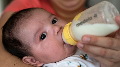 Two-month-old Jose Ismael Gálvez is fed a bottle of formula by his mother, Yury Navas, 29, of Laurel, Md., from her dwindling supply of formula at their apartment in Laurel, Md., Monday, May 23, 2022.