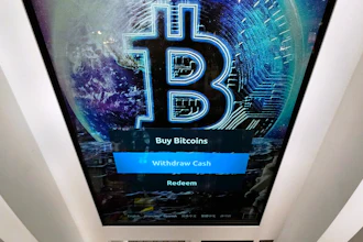 The Bitcoin logo appears on the display screen of a cryptocurrency ATM in Salem, N.H., Feb. 9, 2021.