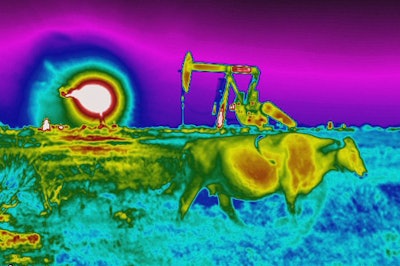 In this photo made with an Optical Gas Imaging thermal camera, a plume of heat from a flare burning off methane and other hydrocarbons is detected in the background next to an oil pumpjack as a cow walks through a field in the Permian Basin in Jal, N.M., Thursday, Oct. 14, 2021.