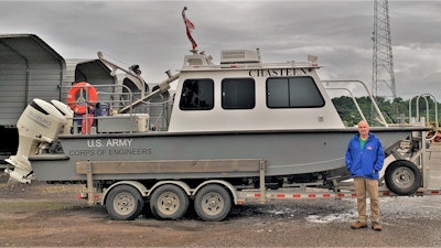 Mark Manning poses with the newly renamed survey vessel, the M/V Chasteen, named in honor of Darian Chasteen. Chasteen recently passed away, losing a hard-fought battle with cancer.