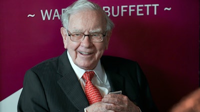 Warren Buffett, chairman and CEO of Berkshire Hathaway, smiles as he plays bridge following the annual Berkshire Hathaway shareholders meeting in Omaha, Neb., on May 5, 2019. Warren Buffett's company bet more on high-tech darlings Apple and Amazon during the second quarter of 2022 while also investing billions in old school oil producers Occidental Petroleum and Chevron.
