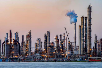 The sun sets at Chalmette refinery in Chalmette, La., located just over the Mississippi River levee May 3, 2020. While the Inflation Reduction Act concentrates on clean energy incentives that could drastically reduce overall U.S. emissions, it also buoys oil and gas interests by mandating leasing of vast areas of public lands and off the nation’s coasts.
