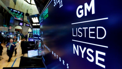 The logo for General Motors appears above a trading post on the floor of the New York Stock Exchange, Monday, April 23, 2018. General Motors will reinstate quarterly dividend payments that were suspended during the pandemic that shut down its factories. The automaker said Friday, Aug. 19, 2022, that the dividend of 9 cents per share will be paid on Sept. 15 to shareholders of record on Aug. 31.