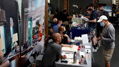 Prospective employers and job seekers interact during during a job fair in West Hollywood, Los Angeles, Sept. 22, 2021.