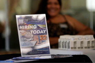 A hiring sign is placed at a booth for prospective employers during a job fair Wednesday, Sept. 22, 2021, in the West Hollywood section of Los Angeles.