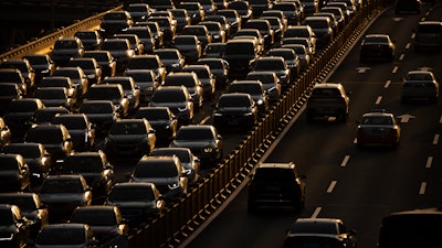 Rush hour traffic backs up along a highway in Beijing, China, on April 23, 2020. Hainan island in the South China Sea said Monday, Aug. 22, 2022 that it will become China's first region to ban sales of gasoline- and diesel-powered cars to curb climate-changing carbon emissions.