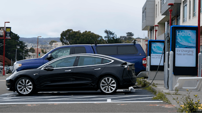 Cars are parked at an electric charging station in San Francisco, Thursday, Aug. 25, 2022. California is poised to required 100% of new cars, trucks and SUVs sold in the state to be powered by electricity or hydrogen by 2035.