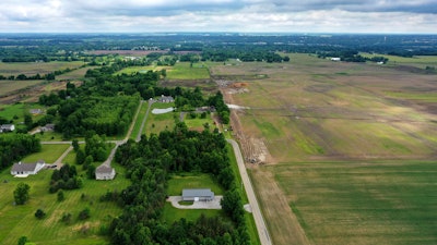 This aerial image taken with a drone on June 9, 2022 shows a portion of land in Johnstown, Ohio, where Intel plans to build two new processor factories. The houses on the left are up for demolition. Intel Corp. plans a Sept. 9 groundbreaking for its planned $20 billion Ohio semiconductor operations with President Joe Biden giving remarks, the company and the the White House said Thursday, Aug. 25, 2022.