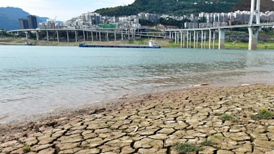 A dried riverbed is exposed after the water level dropped in the Yangtze River in Yunyang county in southwest China's Chongqing Municipality, Tuesday, Aug. 16, 2022. Unusually high temperatures and a prolonged drought are affecting large swaths of China, reducing crop yields and drinking water supplies.