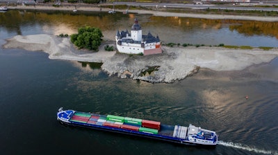 A container ships passes Pfalzgrafenstein castle in the middle of the river Rhine in Kaub, Germany, Friday, Aug. 12, 2022. The Rhine carries low water after a long drought period.
