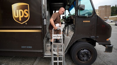 UPS driver Joe Speeler makes a delivery at the Leanon Shops in Mount Lebanon, Pa., on Tuesday, Sept. 21, 2021. United Parcel Service said Wednesday, Sept 7, 2022, it plans to hire more than 100,000 extra workers to help handle an increase in packages during the critical holiday season. That’s similar to the holiday seasons of 2021 and 2020.