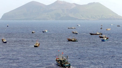 Foreign vessels, some of them have Chinese flags, fish near Torishima, Japan, on Oct. 31, 2014. A Chinese scientific ship bristling with surveillance equipment docked in a Sri Lankan port.