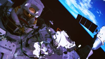 In this photo released by China's Xinhua News Agency, a screen at the Beijing Aerospace Control Center in Beijing shows Chinese astronaut Cai Xuzhe exiting the station lab module Wentian to conduct extravehicular activities, also known as a spacewalk, Saturday, Sept. 17, 2022.