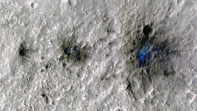 This undated photo released by NASA shows craters that were formed by a Sept. 5, 2021, meteoroid impact on Mars, the first to be detected by NASA’s InSight.