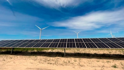 In this image provided by Portland General Electric, windmills and solar panels line a renewable energy facility in Lexington, Ore., on this May 24, 2022.