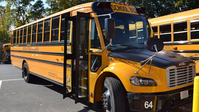 An electric school bus, leased by Beverly Public Schools in Beverly, Mass., rests in a bus yard, Oct. 21, 2021, in Beverly, Mass.