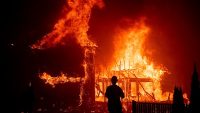 A home burns as the Camp Fire rages through Paradise, Calif., Nov. 8, 2018.