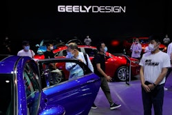 Visitors look at cars produced by Geely at the Auto China 2020 show in Beijing on Sept. 27, 2020. Geely Holding Group, one of China's biggest independent automakers, has bought a 7.6% stake in British luxury brand Aston Martin Lagonda and said Friday, Sept. 30, 2022, that it looks forward to potential opportunities to collaborate.