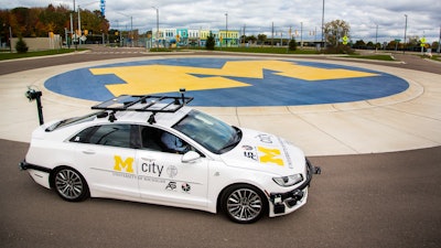 An open-source connected and automated research vehicle is parked on the roundabout at the Mcity Test Facility, the world’s first purpose-built proving ground for testing the performance and safety of connected and automated vehicles and technologies under controlled and realistic conditions.