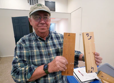 Co owner of Building Resilient Solutions, Kerry Shackelford displays pine boards that they use to test flood resistance at his lab Tuesday, Oct. 4, 2022, in Suffolk , Va.