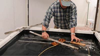 Co owner of Building Resilient Solutions, Kerry Shackelford hooks up pine boards that are used to test flood resistance at his lab Tuesday, Oct. 4, 2022, in Suffolk , Va.