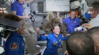 In this image from video made available by NASA, Russian Cosmonaut Anna Kikina enters the International Space Station from a SpaceX Crew Dragon capsule on Thursday, Oct. 6, 2022. Kikina is the first Russian to launch from the U.S., in 20 years.