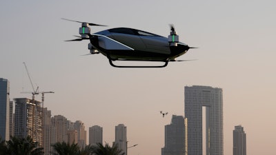 A XPeng X2, an electric flying taxi developed by the Guangzhou-based XPeng, Inc's aviation affiliate, is tested in front of the Marina District in Dubai, United Arab Emirates, Monday, Oct. 10, 2022. Monday’s demonstration was held with an empty cockpit, but the company says it carried out a manned flight test last year of the two-passenger vehicle.