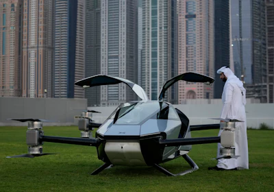 A man looks at the XPeng X2, an electric flying taxi developed by the Guangzhou-based XPeng, Inc's aviation affiliate, being tested in front of the Marina District in Dubai, United Arab Emirates, Monday, Oct. 10, 2022. Monday’s demonstration was held with an empty cockpit, but the company says it carried out a manned flight test last year of the two-passenger vehicle.