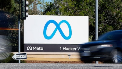 A car passes Facebook's new Meta logo on a sign at the company headquarters on Oct. 28, 2021, in Menlo Park, Calif.
