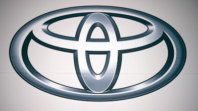A logo of Toyota Motor Corp. at a dealer Wednesday, May 11, 2022, in Tokyo. In a Tuesday, Oct. 12, 2022, statement, Toyota Motor Corp. says it has begun assembling autos in Myanmar after a more than yearlong delay following a military takeover in February 2021.