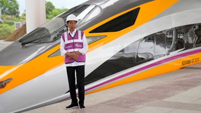 Indonesian President Joko Widodo stands near a newly-unveiled Comprehensive Inspection Train (CIT) unit during his visit at the Jakarta-Bandung Fast Railway station in Tegalluar, West Java, Indonesia, Thursday, Oct. 13, 2022.