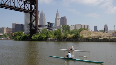 Two rowers paddle along the Cuyahoga River in Cleveland on July 12, 2011. Tuesday, Oct. 18, 2022, is the 50th anniversary of Congress passing the Clean Water Act to protect U.S. waterways from abuses like the oily industrial pollution that caused Ohio's Cuyahoga River to catch on fire in 1969.