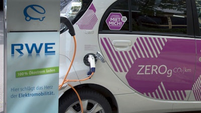 In this Wednesday, April 27, 2016 photo an e-car is connected with a public charge base in Berlin, Germany.