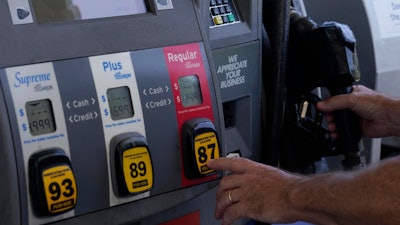 A customer pumps gas at an Exxon gas station, Tuesday, May 10, 2022, in Miami.