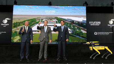 Chung Eui-sun, left, executive chairman of Hyundai Motor Group, Georgia Gov. Brian Kemp, and Jose Munoz, president and COO of Hyundai, celebrate with a champagne toast during the official groundbreaking for the Hyundai Meta Plant on Tuesday, Oct. 25, 2022 in Ellabell, Ga.