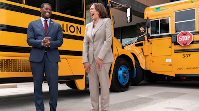 Vice President Kamala Harris, right, laughs with Environmental Protection Agency Administrator Michael Regan, during a tour of electric school buses at Meridian High School in Falls Church, Va., May 20, 2022.