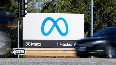 A car passes Facebook's new Meta logo on a sign at the company headquarters on Oct. 28, 2021, in Menlo Park, Calif.
