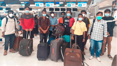 In this photo provided by the Ministry of External Affairs, Indian workers rescued after they were lured by agents for fake job opportunities in the information technology sector in Thailand arrive at the airport in Chennai, India, Wednesday, Oct. 5, 2022. Arindam Bagchi, the External Affairs Ministry spokesperson, said some fraudulent IT companies appear to be engaged in digital scamming and forged cryptocurrencies. The Indian workers were held captive and forced to commit cyber fraud, he told reporters.