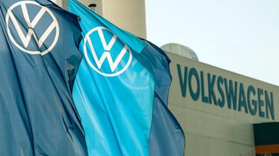 Company logo flags wave in front of a Volkswagen factory building in Zwickau, Germany, on April 23, 2020.