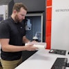 Paul Brackman loads 3D-printed metal samples into a tower for examination using an X-ray CT scan in DOE’s Manufacturing Demonstration Facility at ORNL.