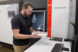 Paul Brackman loads 3D-printed metal samples into a tower for examination using an X-ray CT scan in DOE’s Manufacturing Demonstration Facility at ORNL.